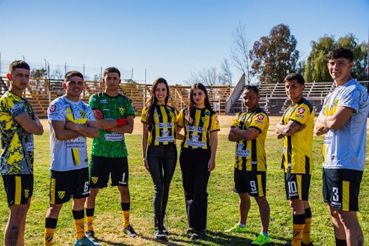 Seven soccer players and two officials in team uniforms on a sunny day.