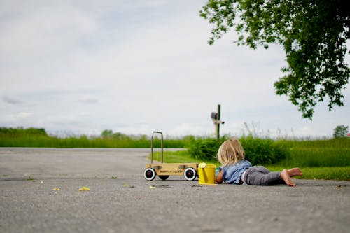 Ragazza Sdraiata Sulla Strada Davanti Al Carrello