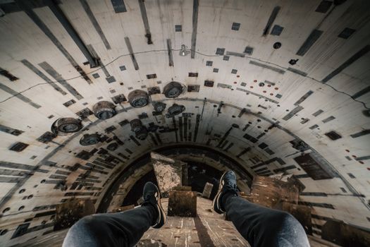 Adventurous view of a person exploring an underground tunnel in Spain, showcasing urban exploration.