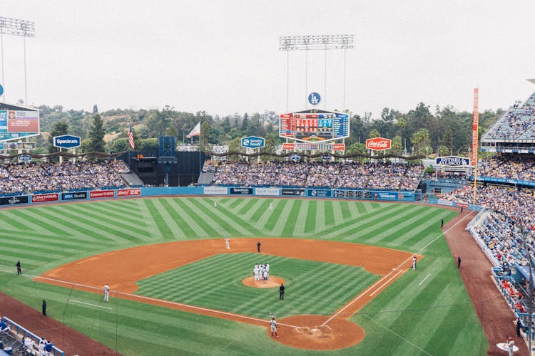 Men Playing Baseball In Stadium