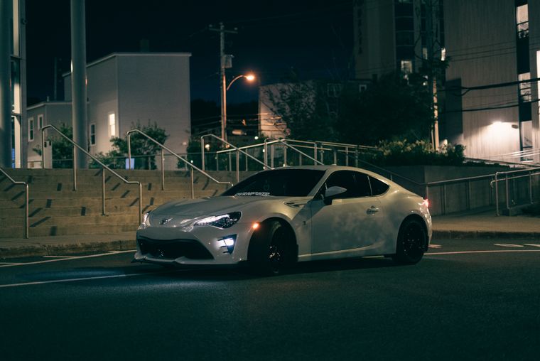 Sports car on a wet city street at night — Erik Mclean on Pexels