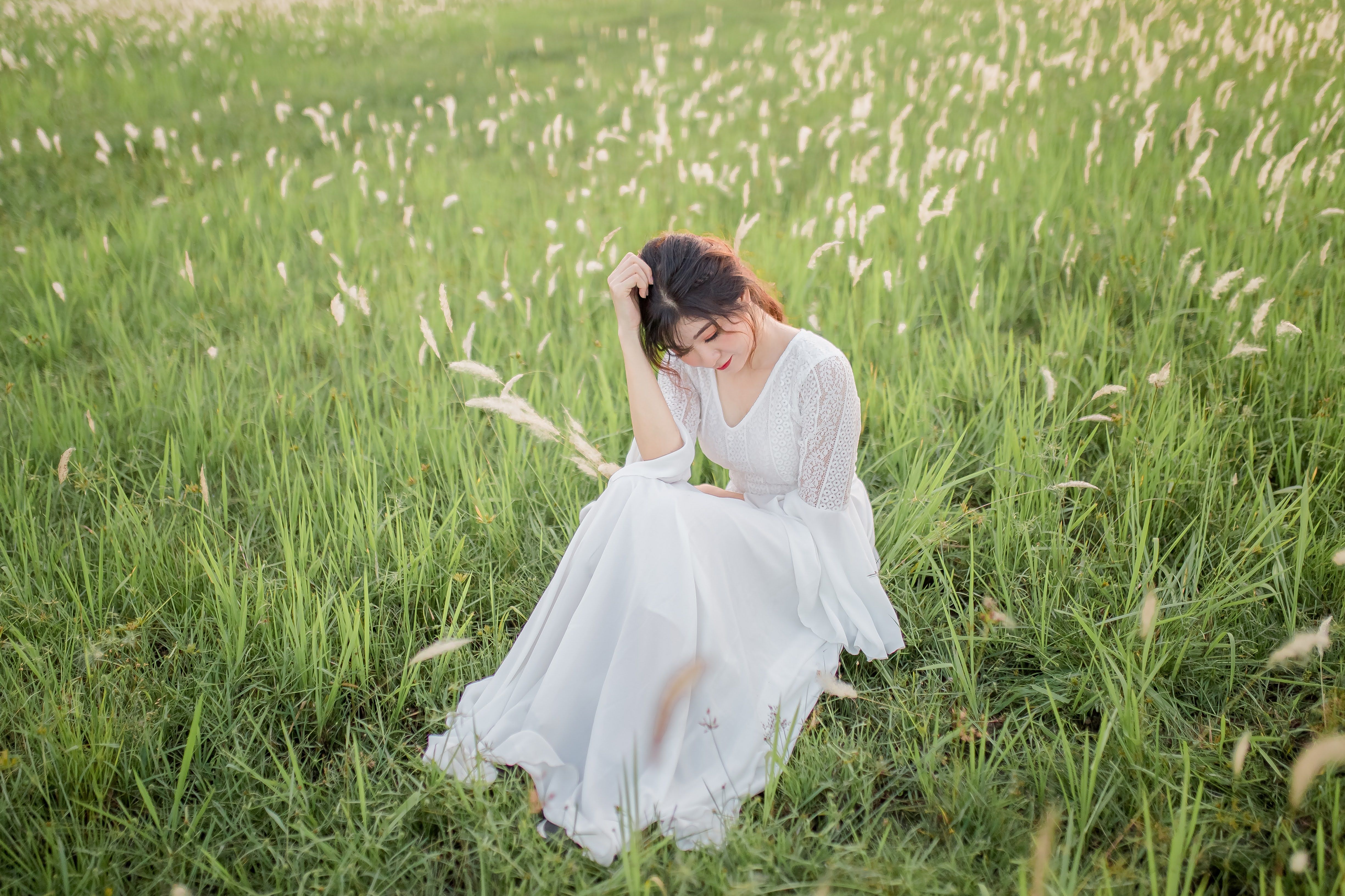Woman in White Dress Sitting on Meadow · Free Stock Photo