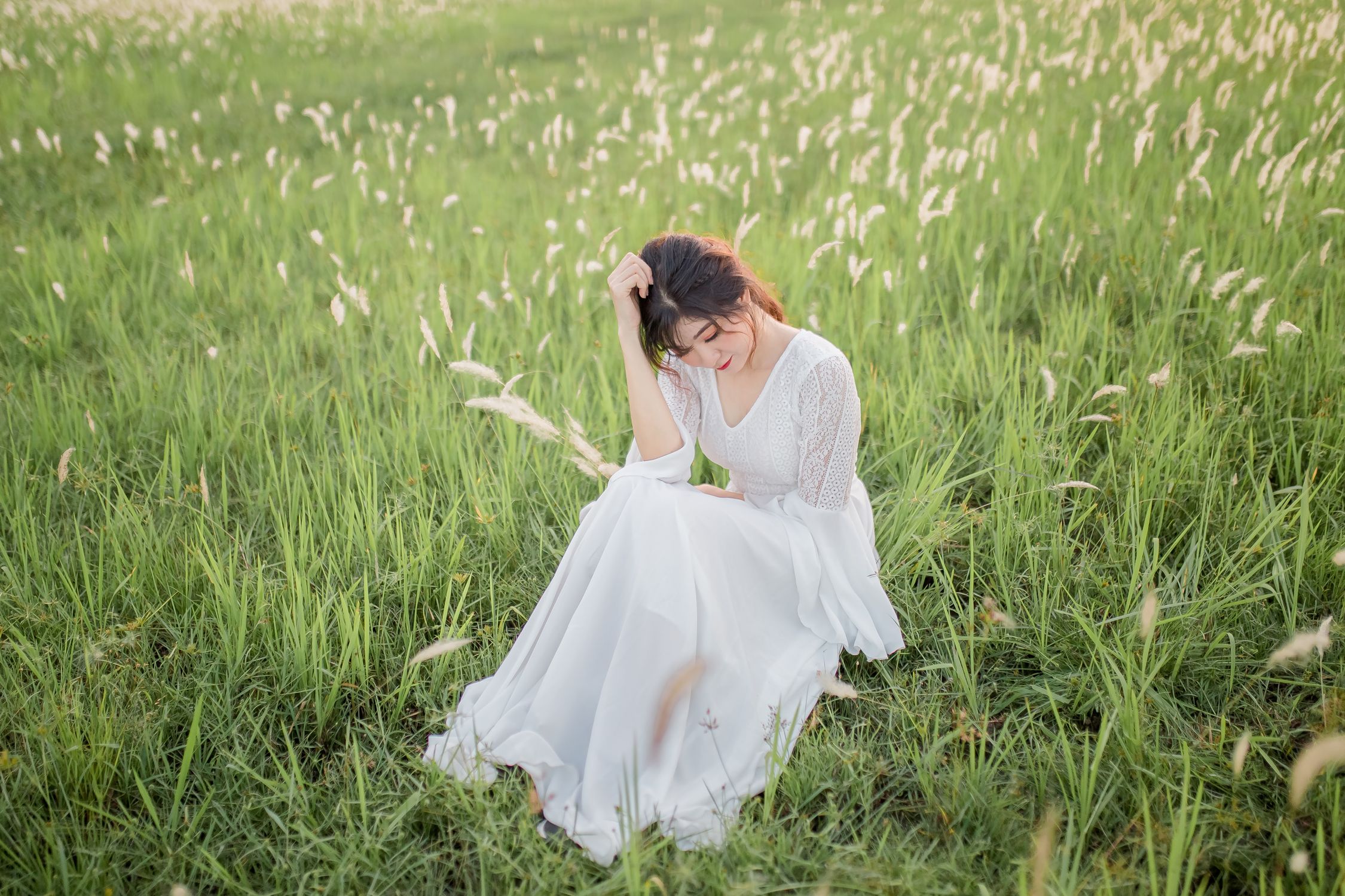 Woman in White Dress Sitting on Meadow · Free Stock Photo