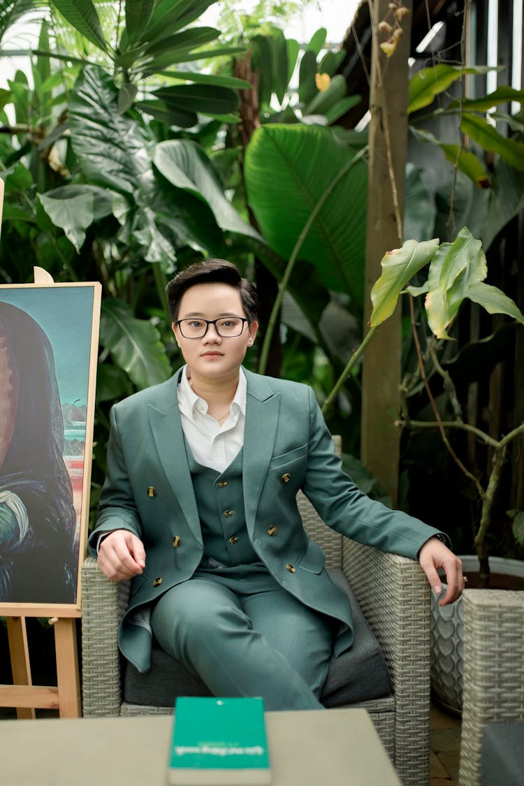 Woman Sitting In Green Suit