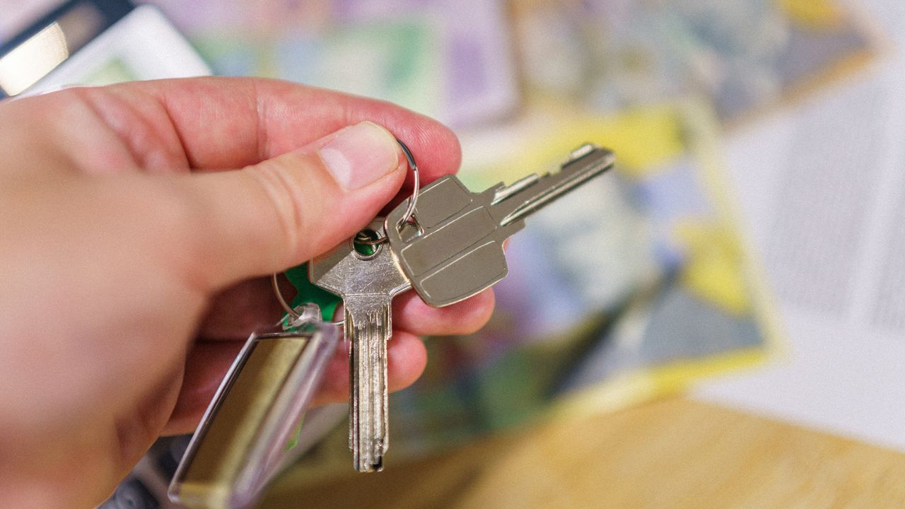 Home savings progress toward house keys House keys with financial documents representing progress toward a home purchase
