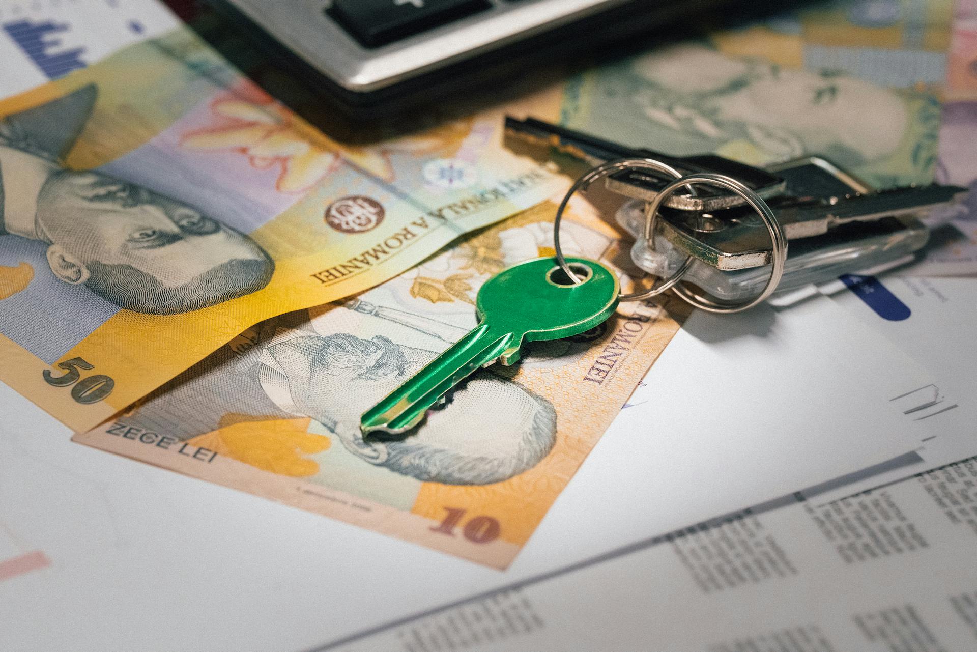 Close-up of Romanian banknotes with a set of keys, representing real estate investment and financial planning.