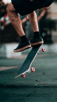 Close-up of a skateboarder performing an impressive trick outdoors.