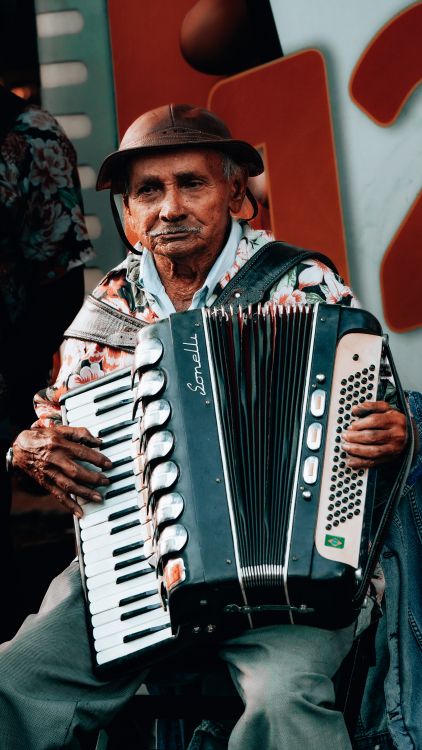 An Old Man Playing An Accordion In A Street Free Stock Photo an-old-man-playing-an-accordion-in-a-street-free-stock-photo
