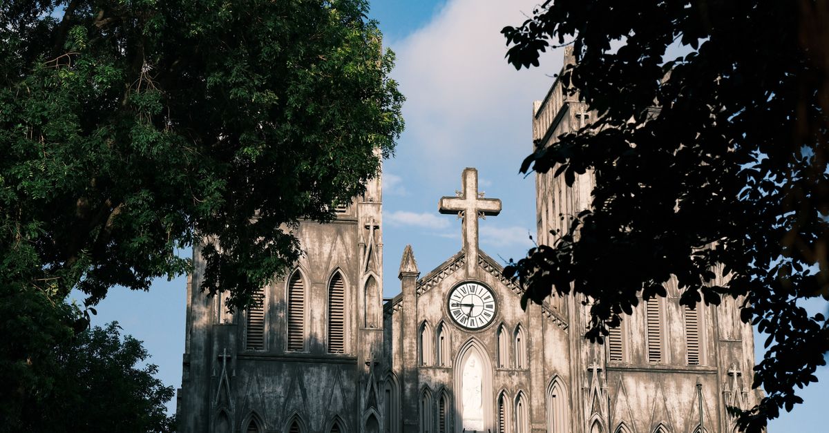 a clock showing 2:00 with a cross or stained glass effect