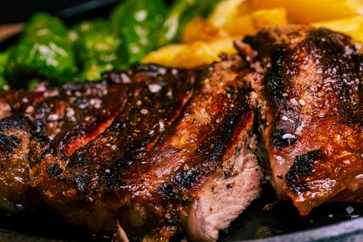 Juicy grilled steak seasoned to perfection, accompanied by fresh vegetables.