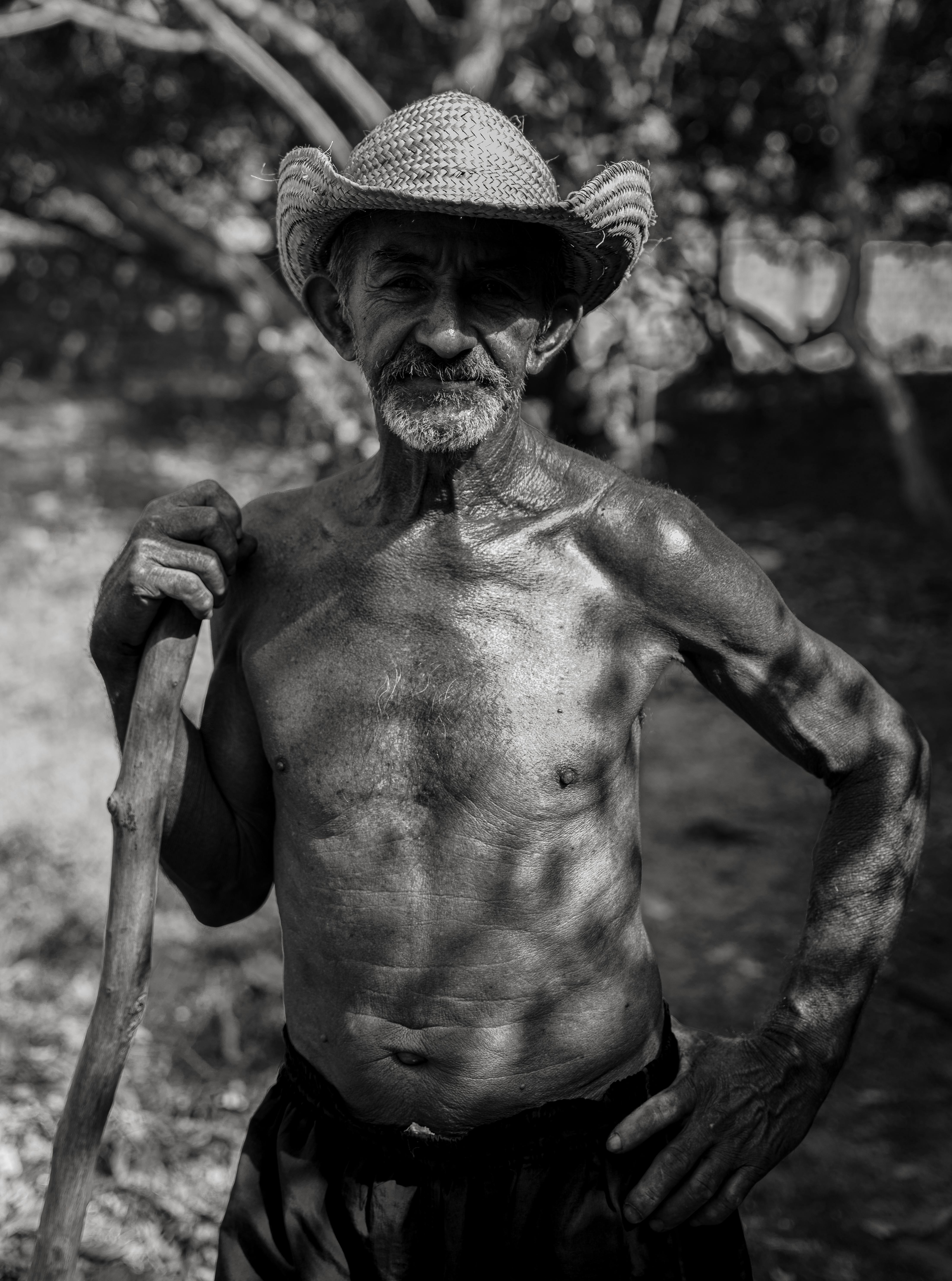An old man with a hat and a stick