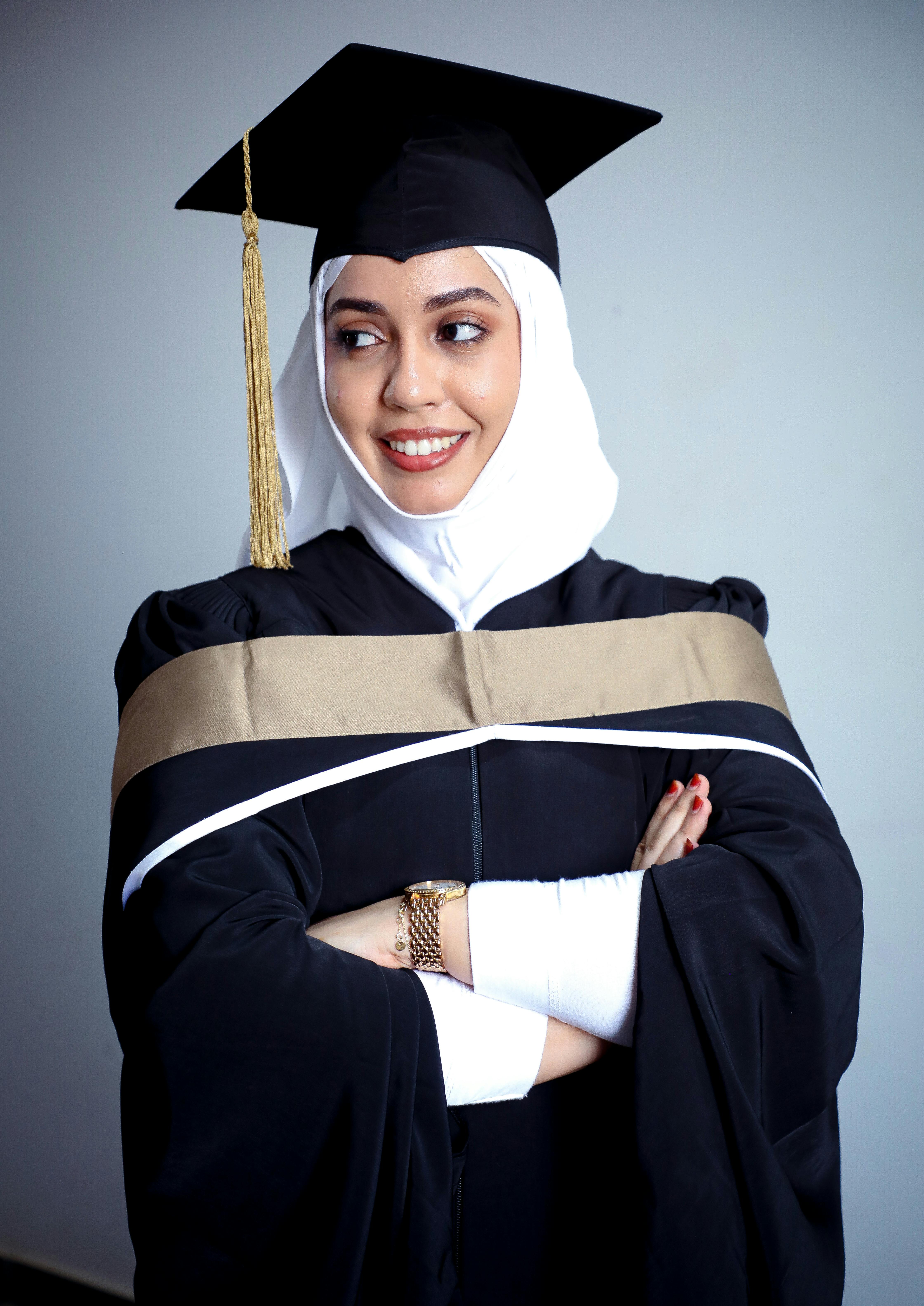 a woman in a graduation gown posing for the camera