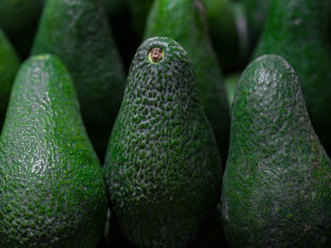 Detailed close-up of ripe avocados showcasing vibrant green textures, perfect for healthy eating.