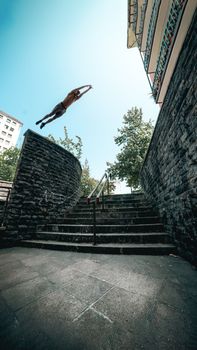 Experience the thrill of parkour with a daring leap across urban architecture in Spain.