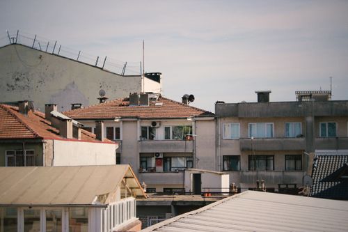 Free A scenic view of urban residential rooftops with clear skies. Stock Photo