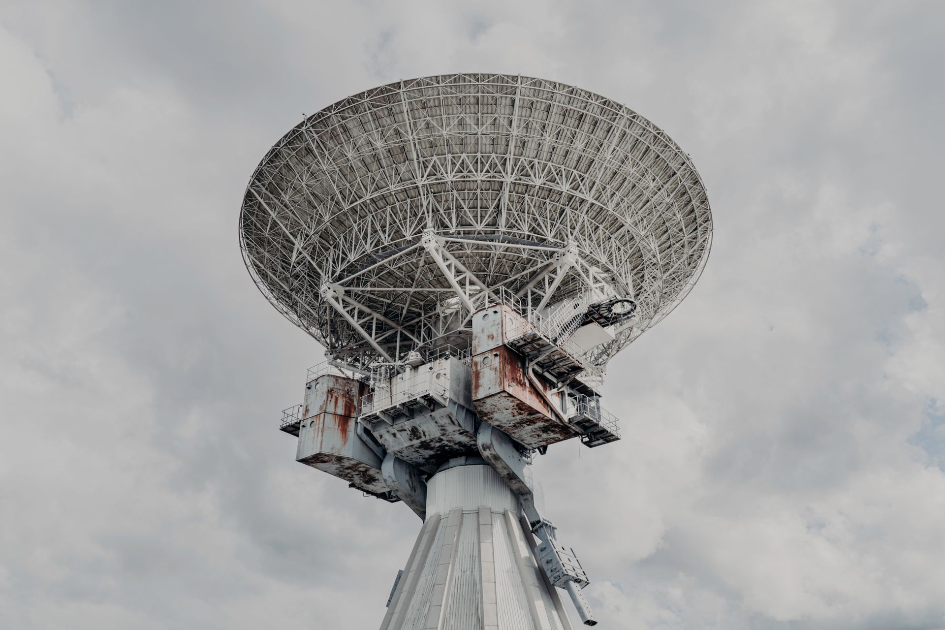 Conjunto de antenas radar apuntando al horizonte bajo cielo nublado.