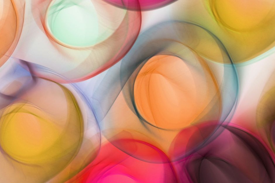 Vibrant circular abstract art with translucent colors blending beautifully.