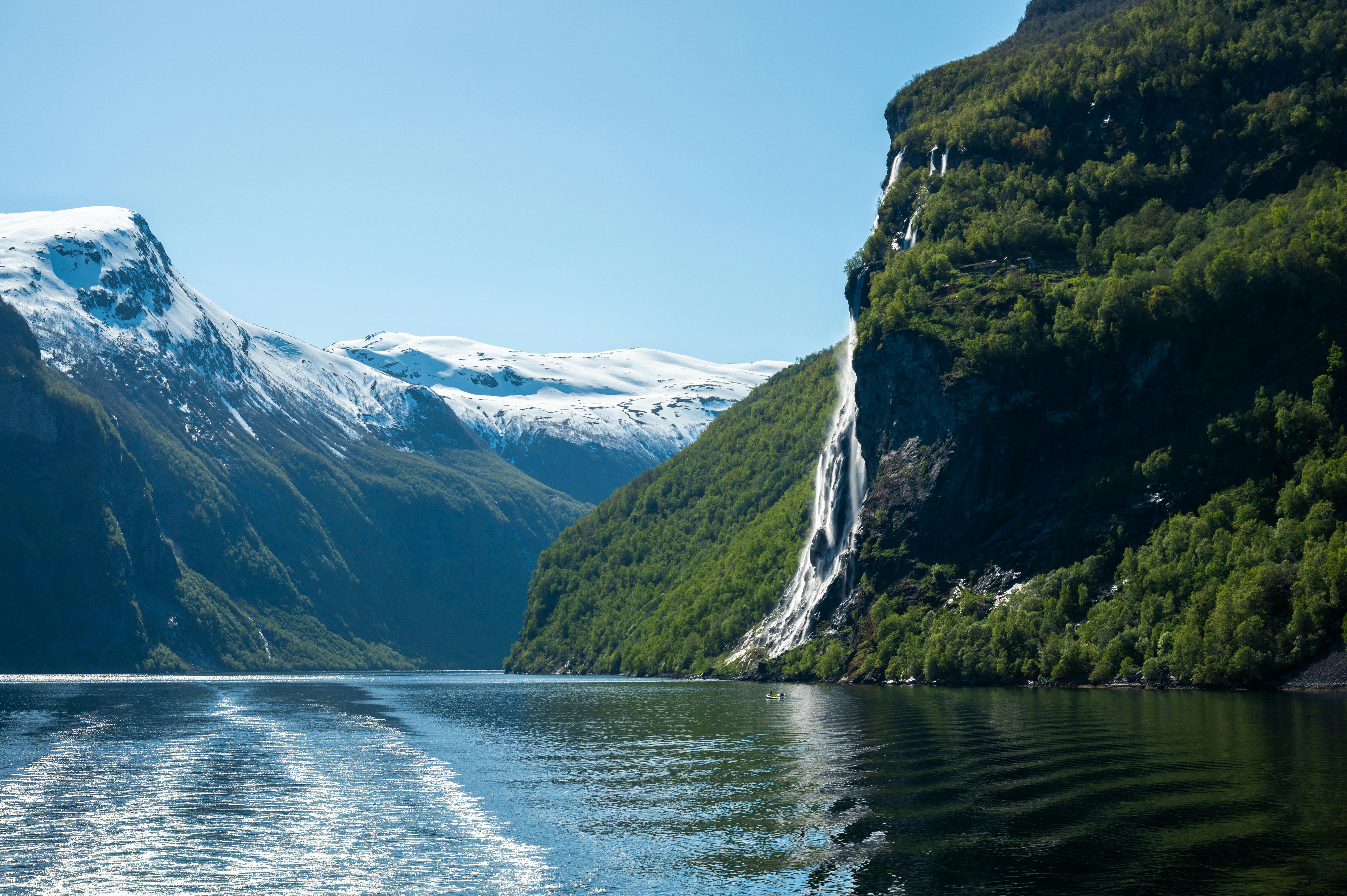 a boat is traveling down a river in norway