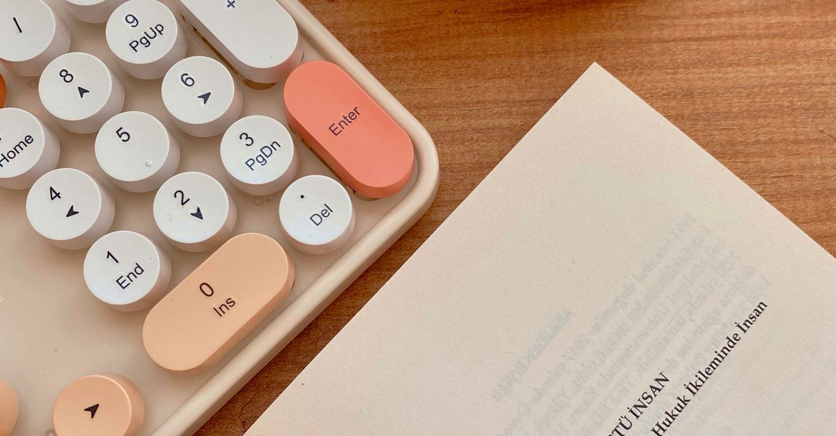 A book, a pen, and a calculator on a table