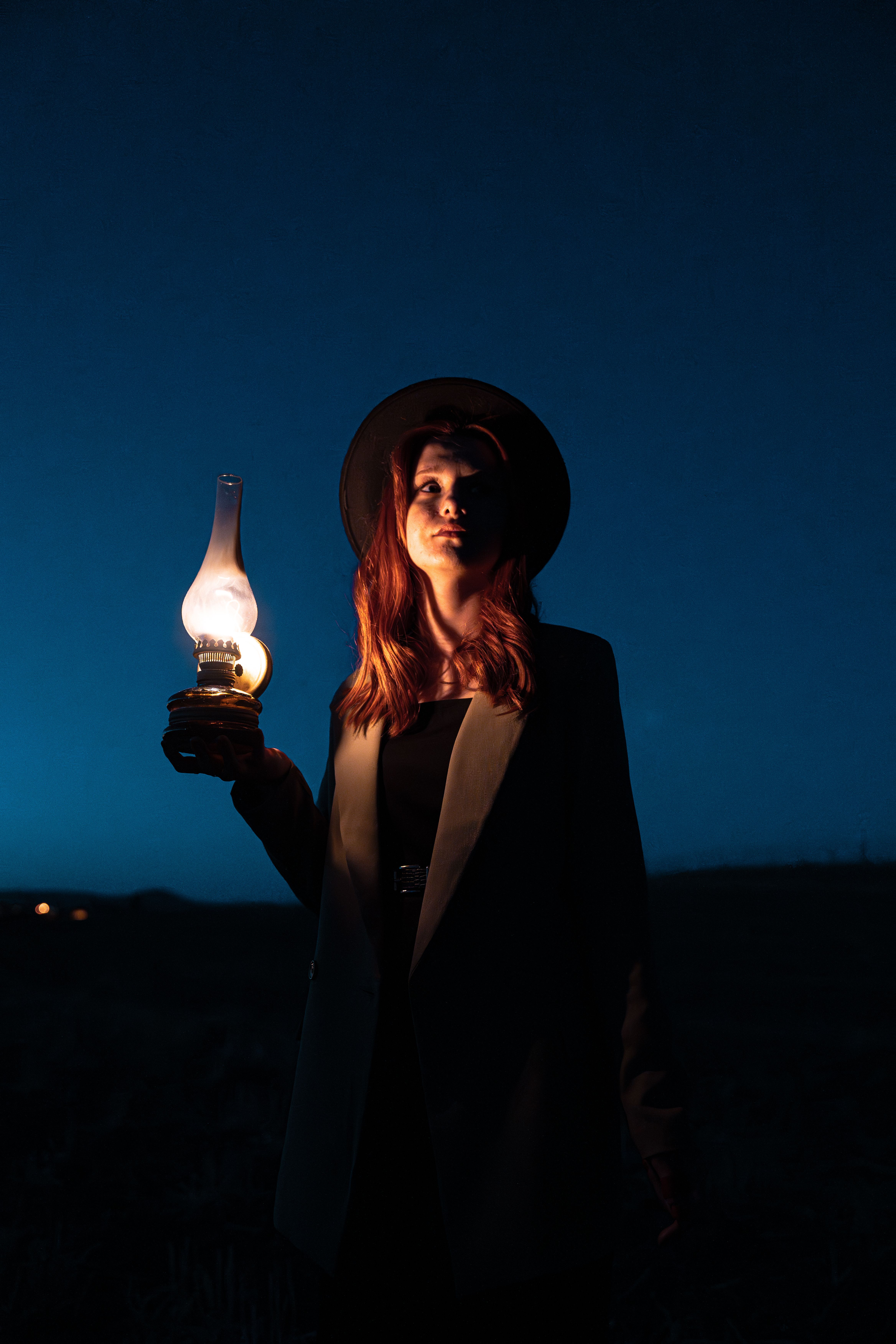 A woman holding a lantern in the dark · Free Stock Photo