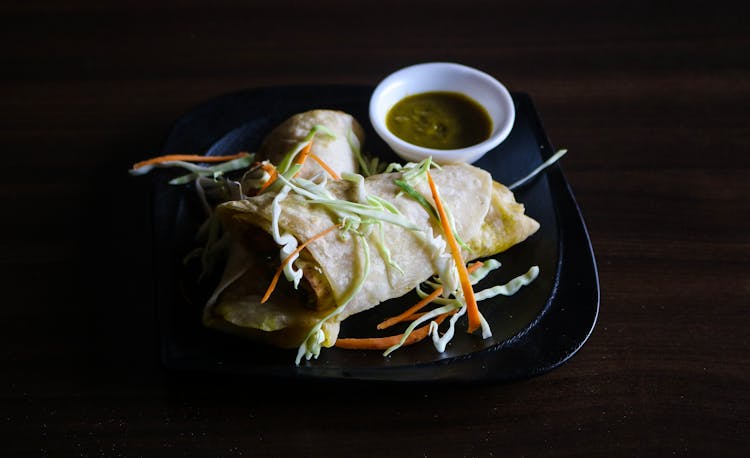 Wrapped Food With Dipping Sauce On Plate