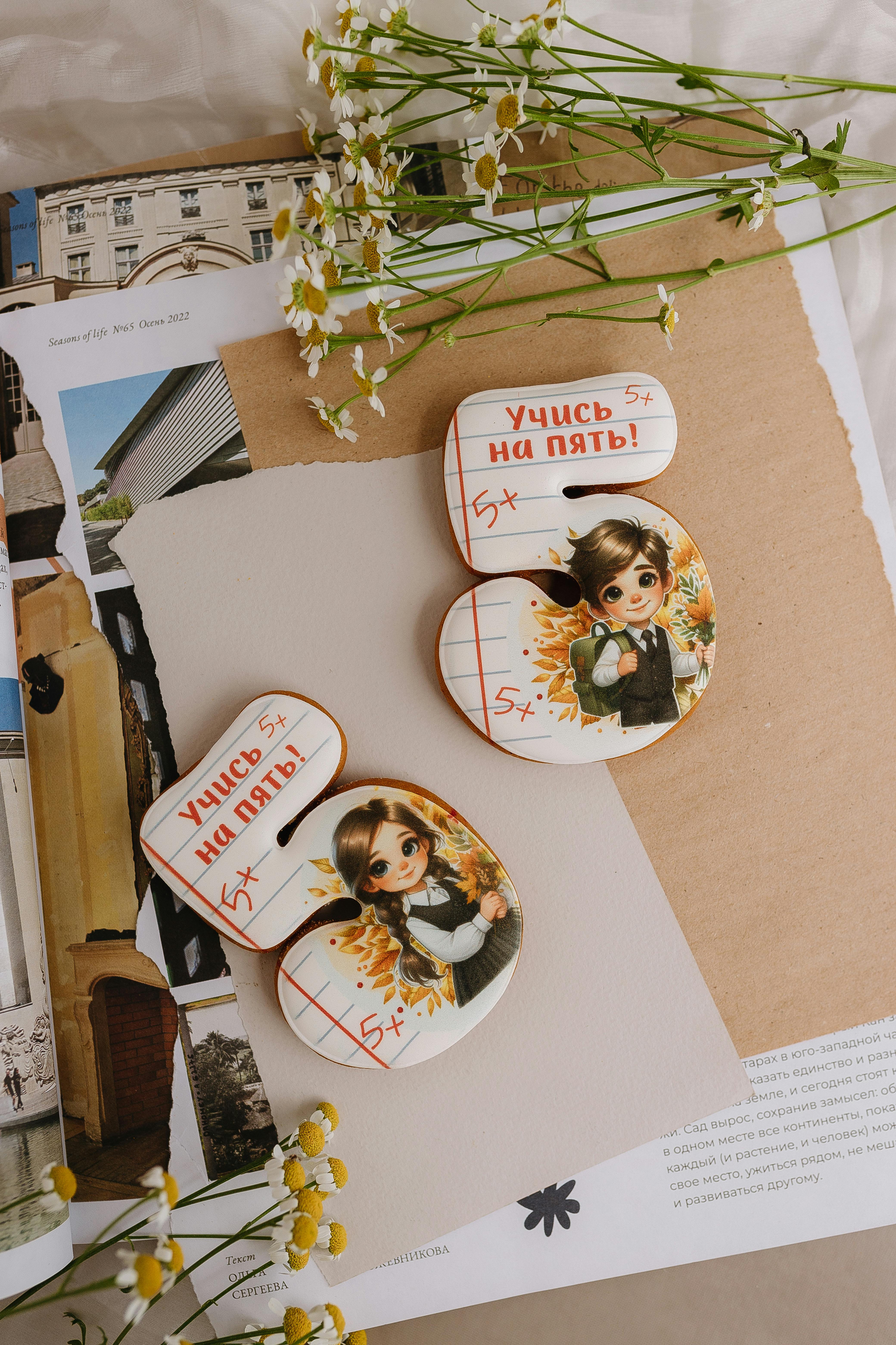 two buttons with pictures of flowers and a book