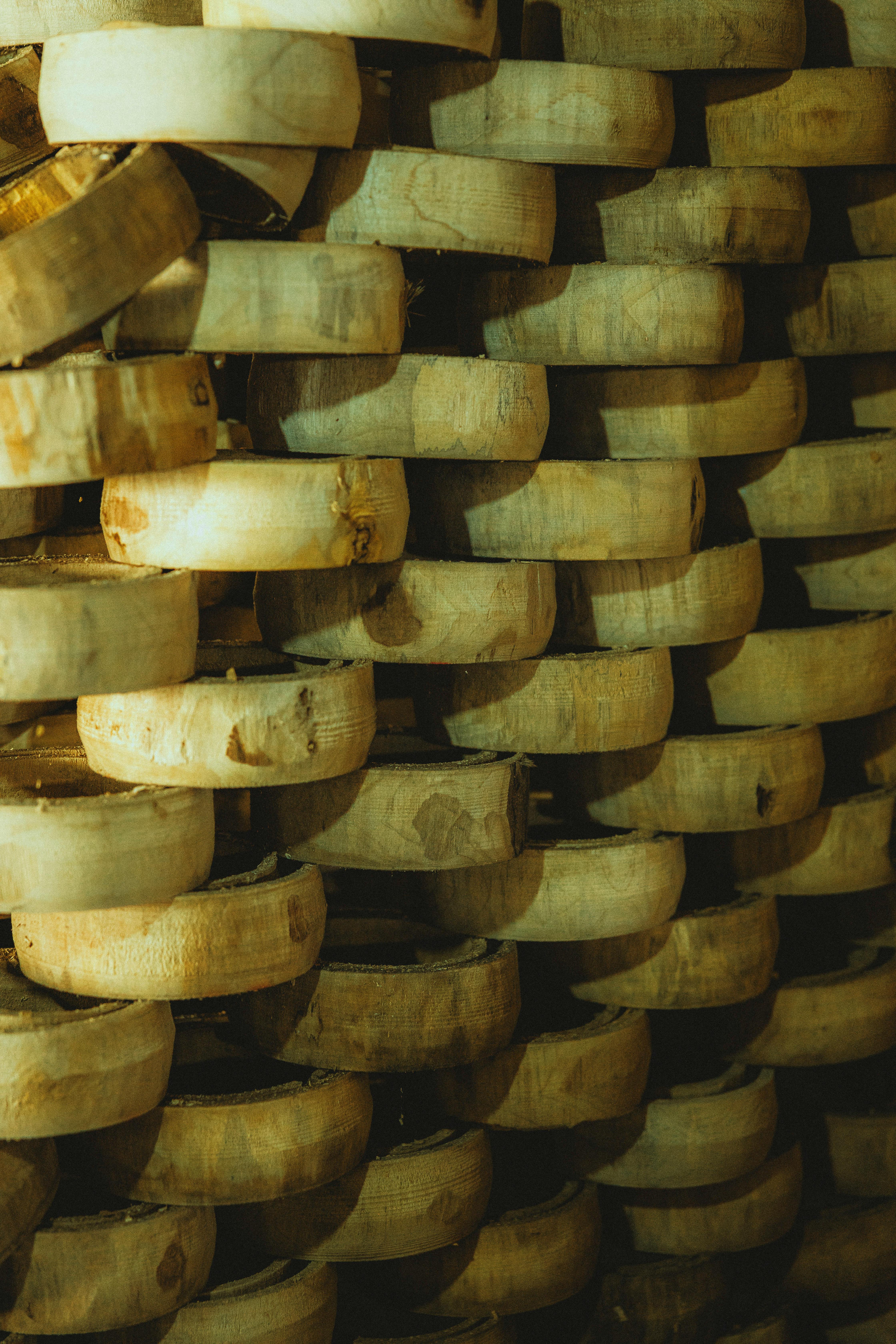 a stack of wooden bowls on a wall