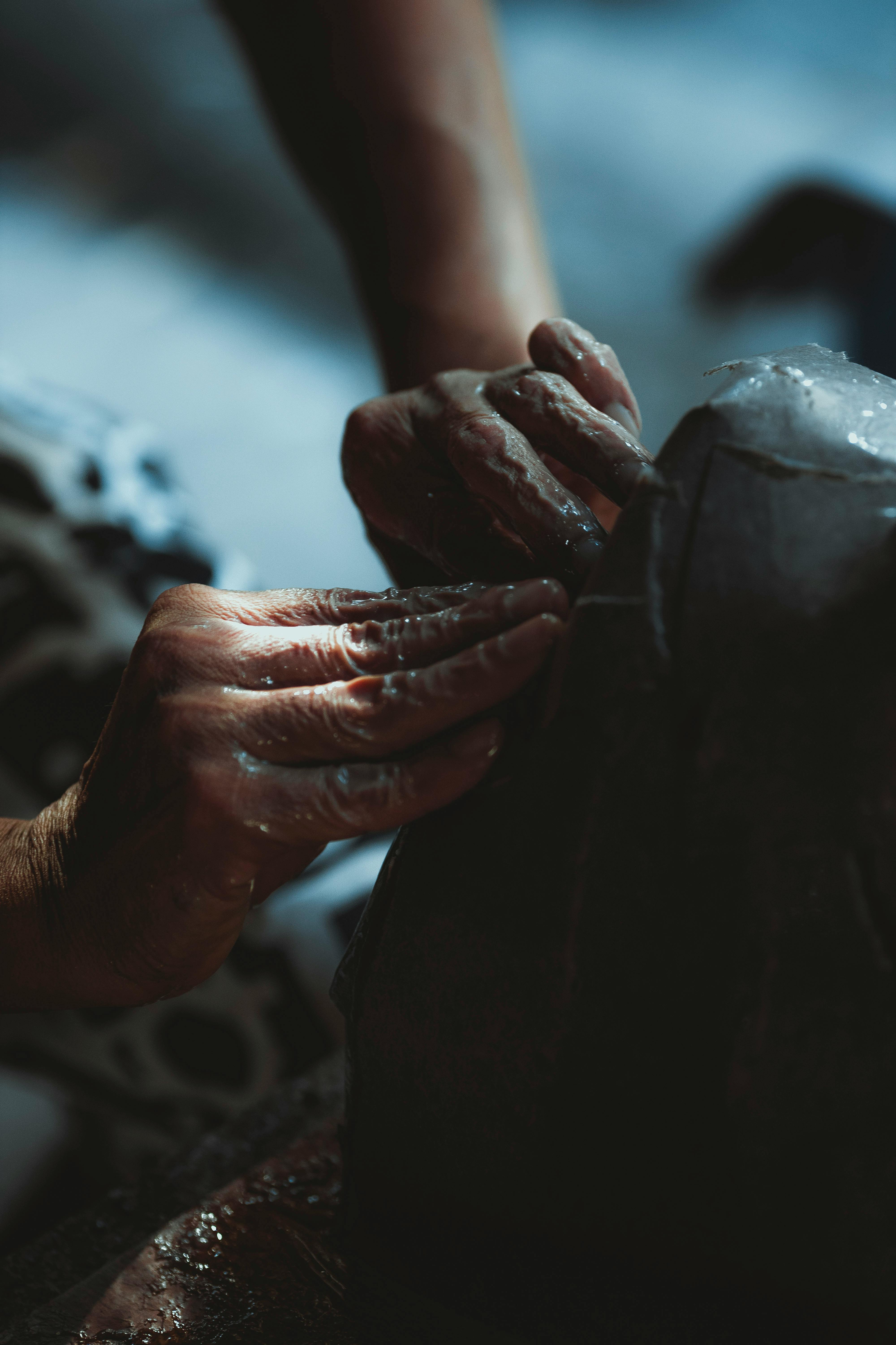 a person is making a sculpture with their hands