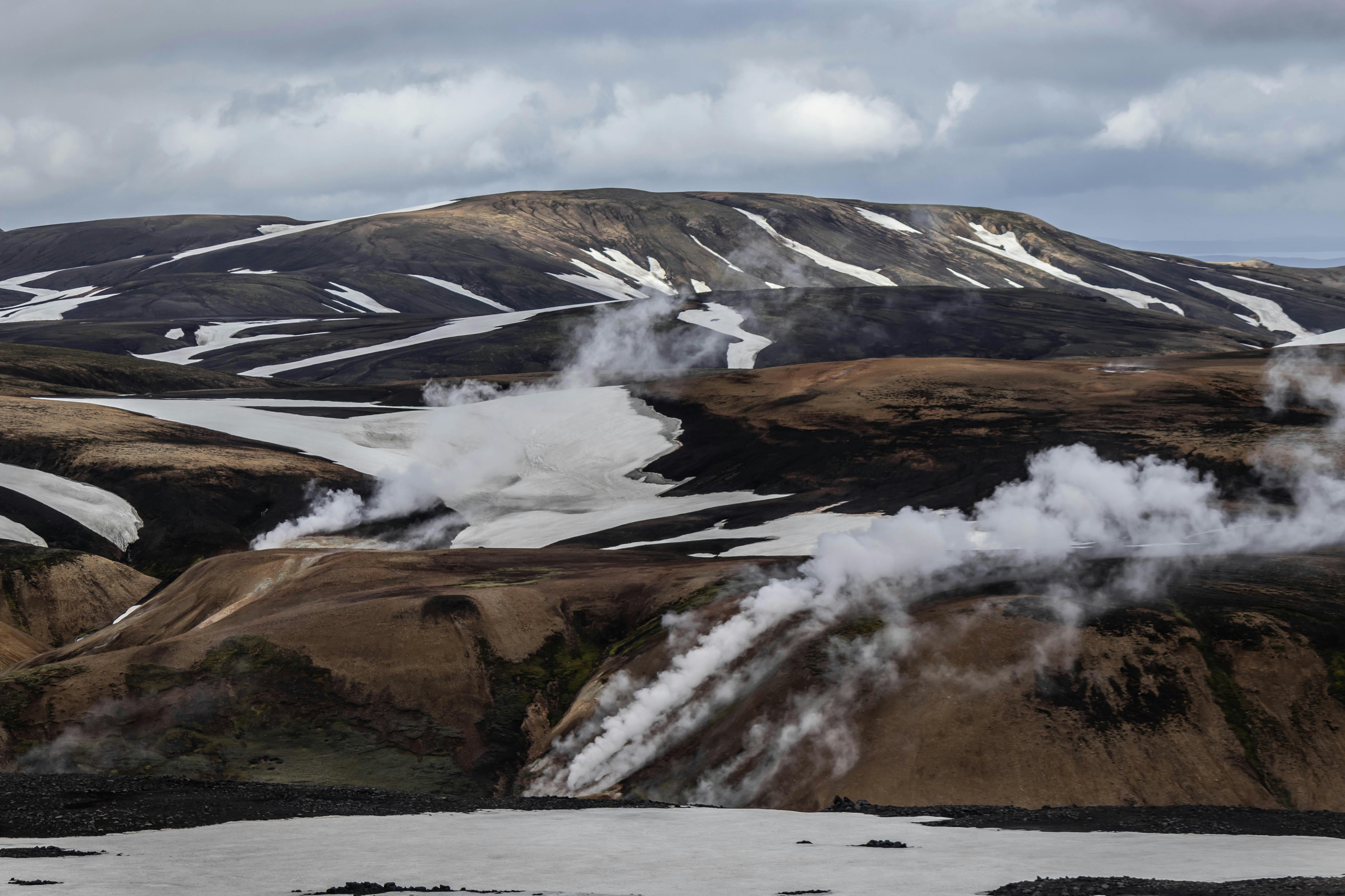 steam rising from the ground in a snowy landscape