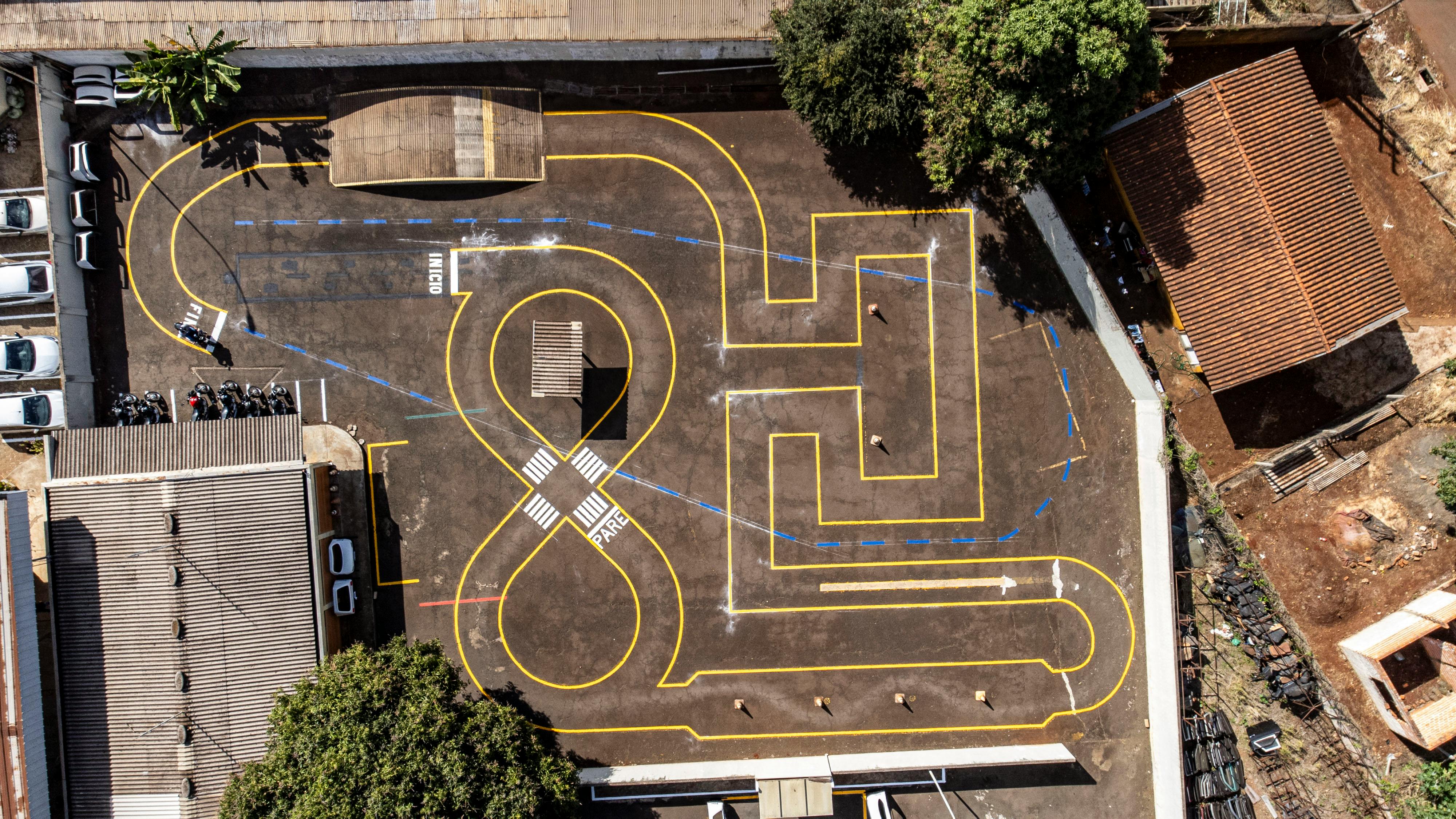 Aerial shot of a road safety training course in Londrina, Brazil showcasing intricate traffic patterns.