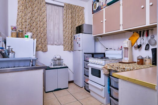 A compact kitchen featuring modern appliances and cozy design elements, perfect for small homes.