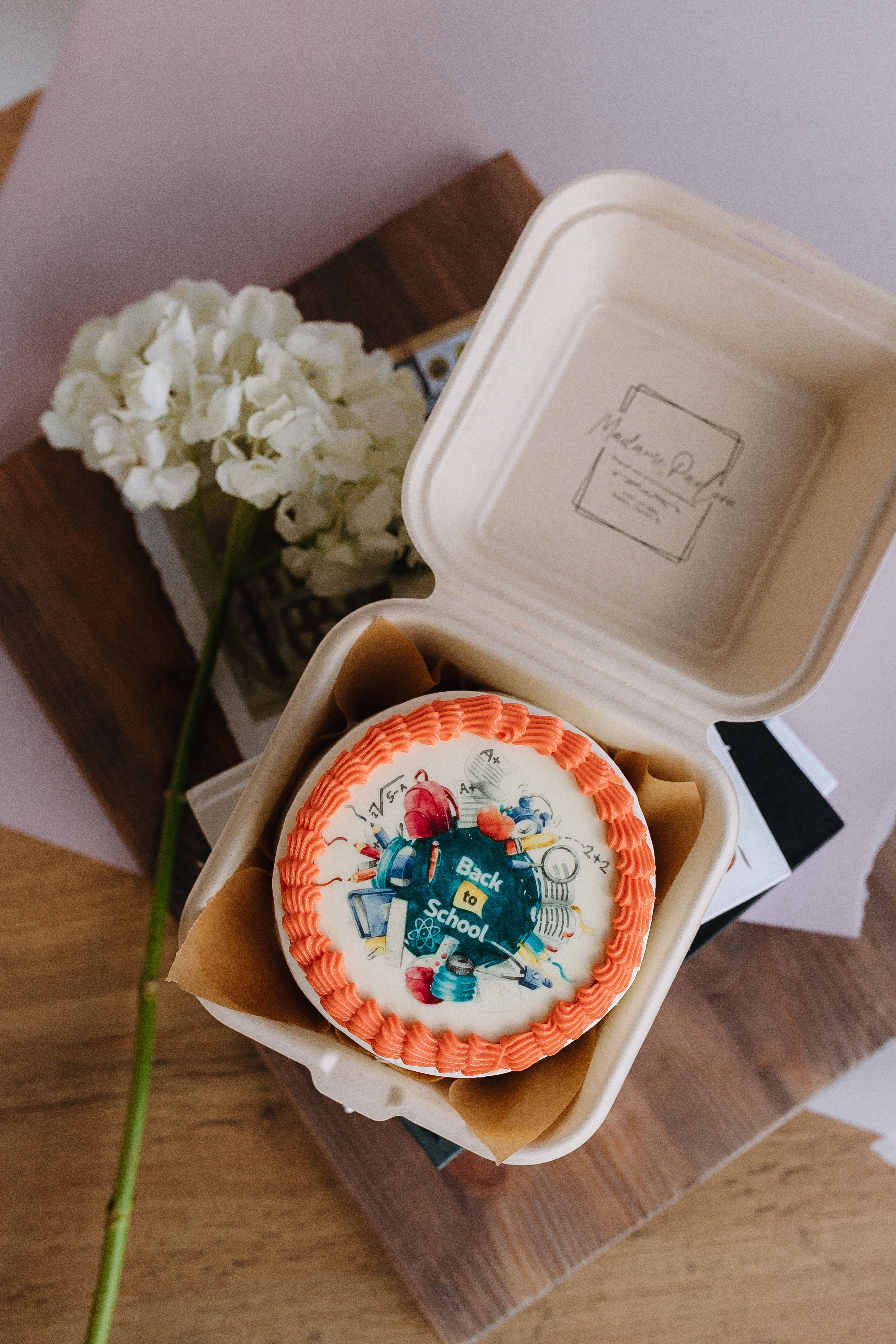 A small box with a cake inside it on a table · Free Stock Photo