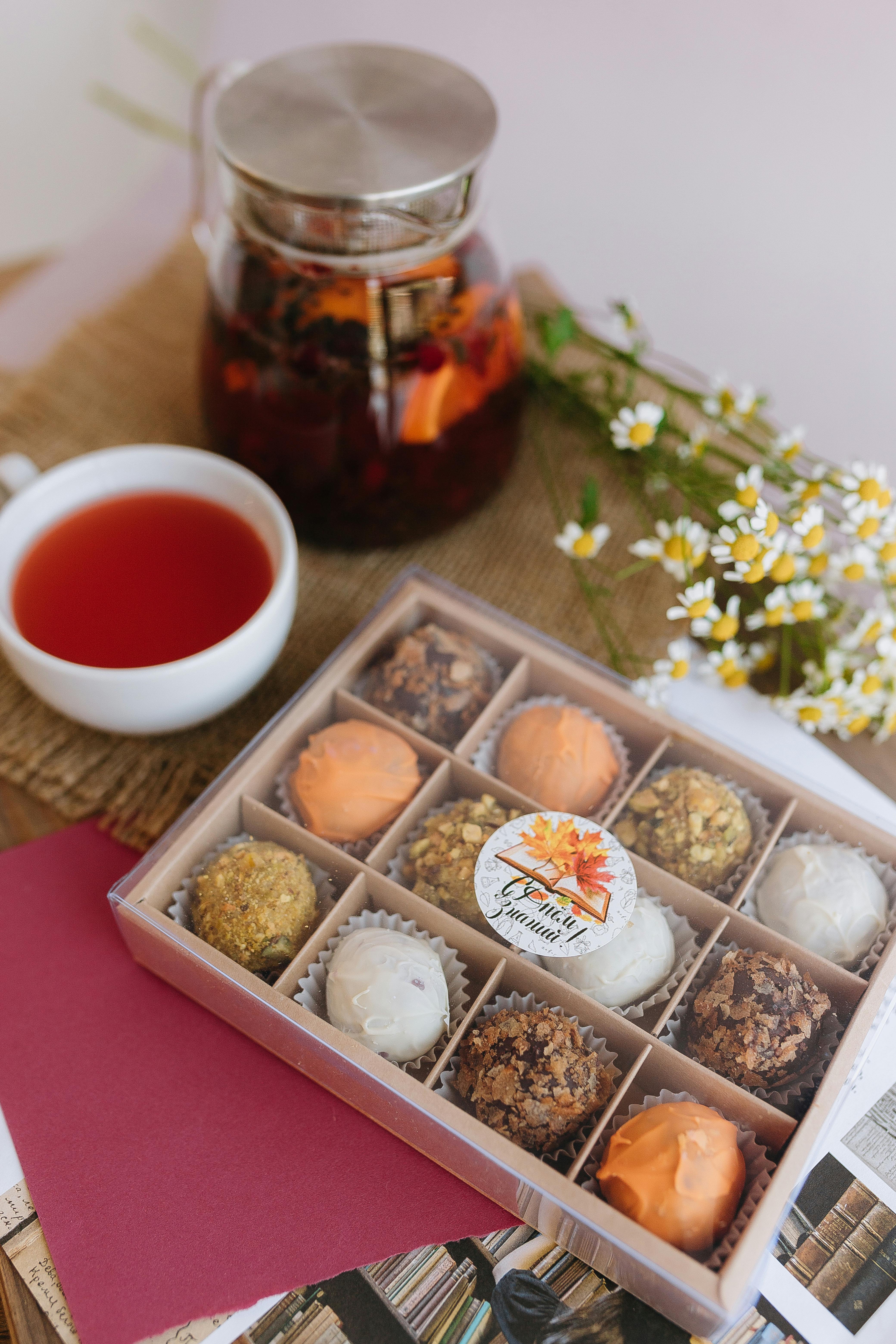 a box of tea and a cup of tea next to a tray of tea