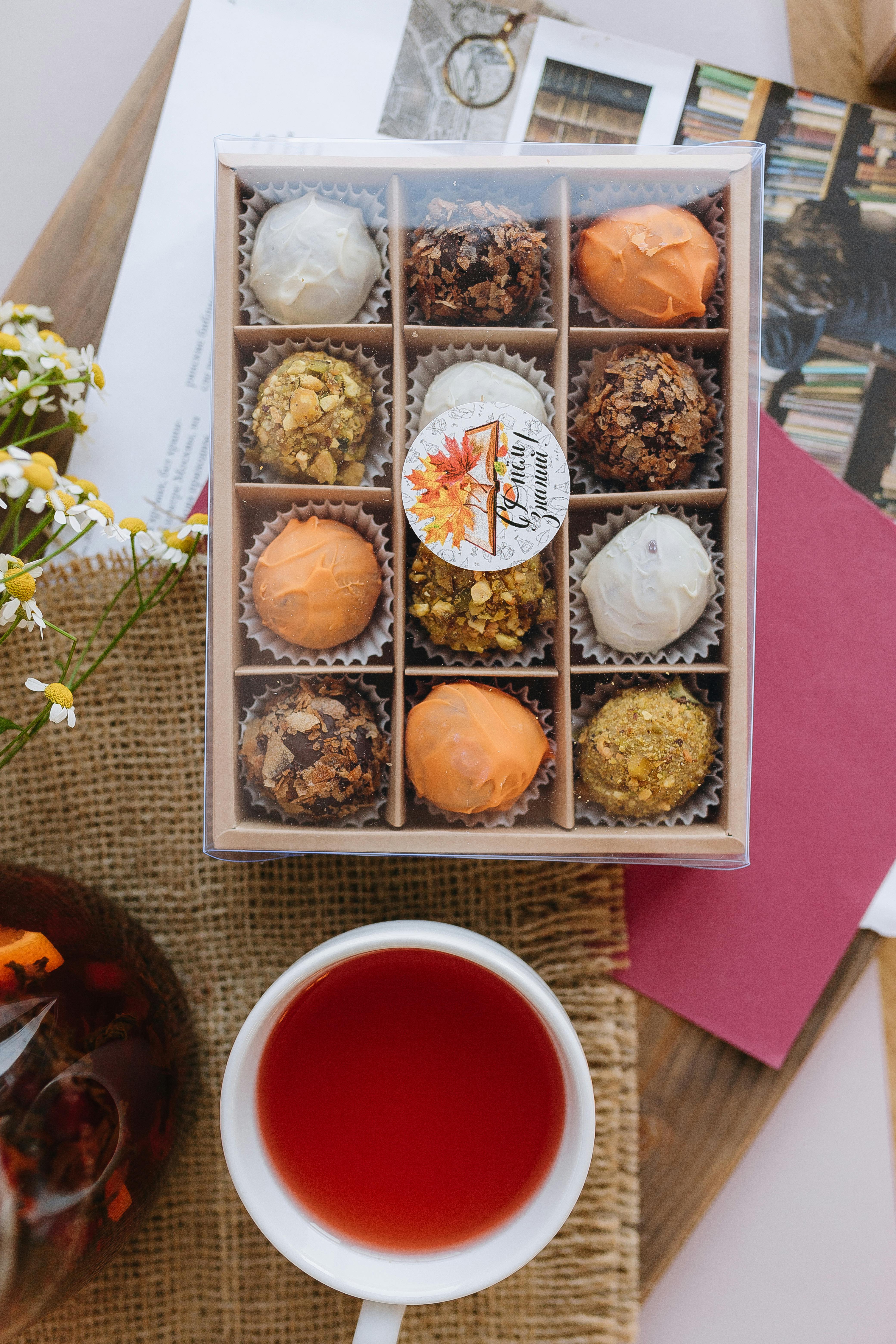 a box of tea and a cup of tea next to a box of tea