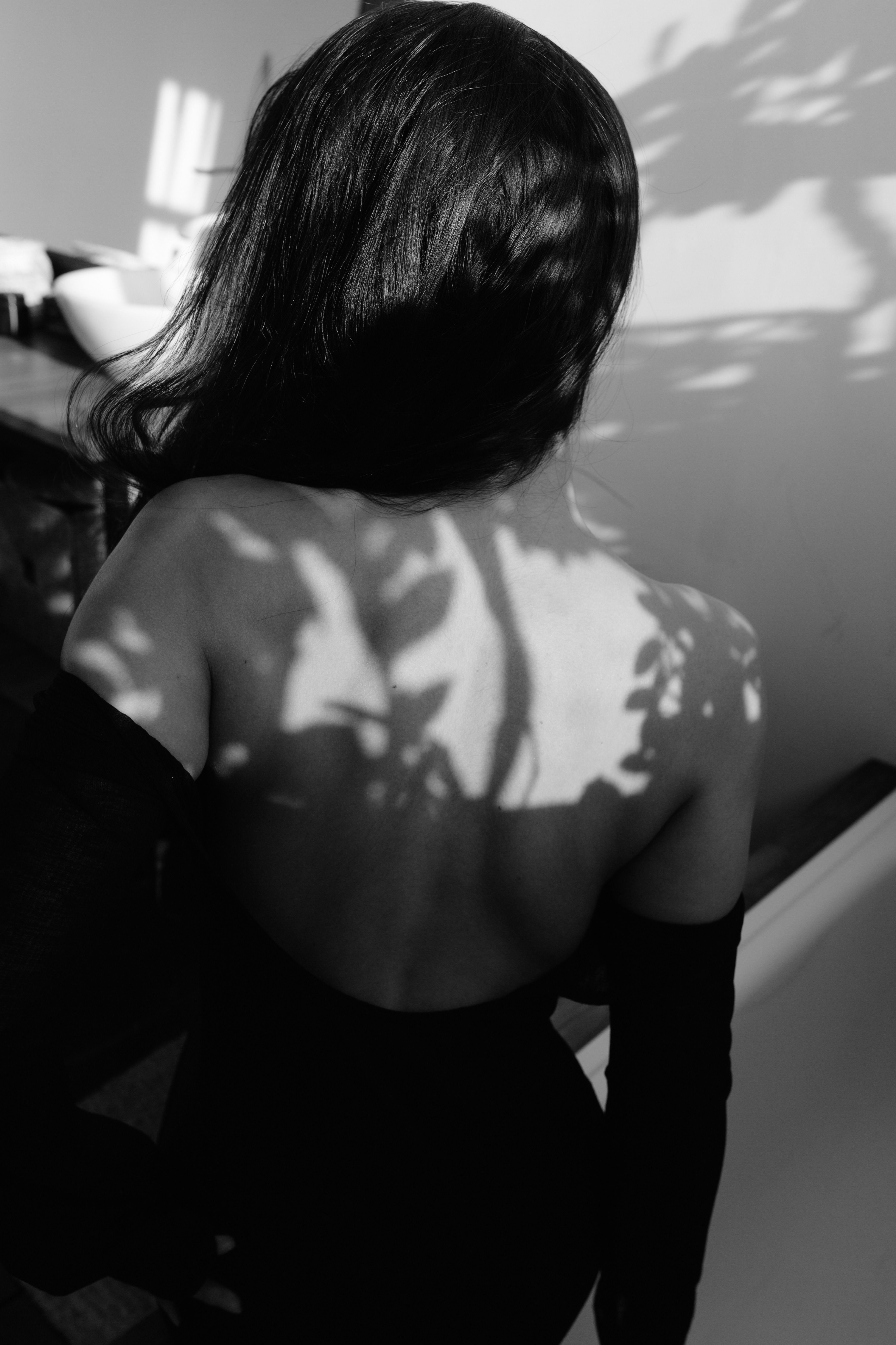 A woman in a black dress with her back to the camera · Free Stock Photo