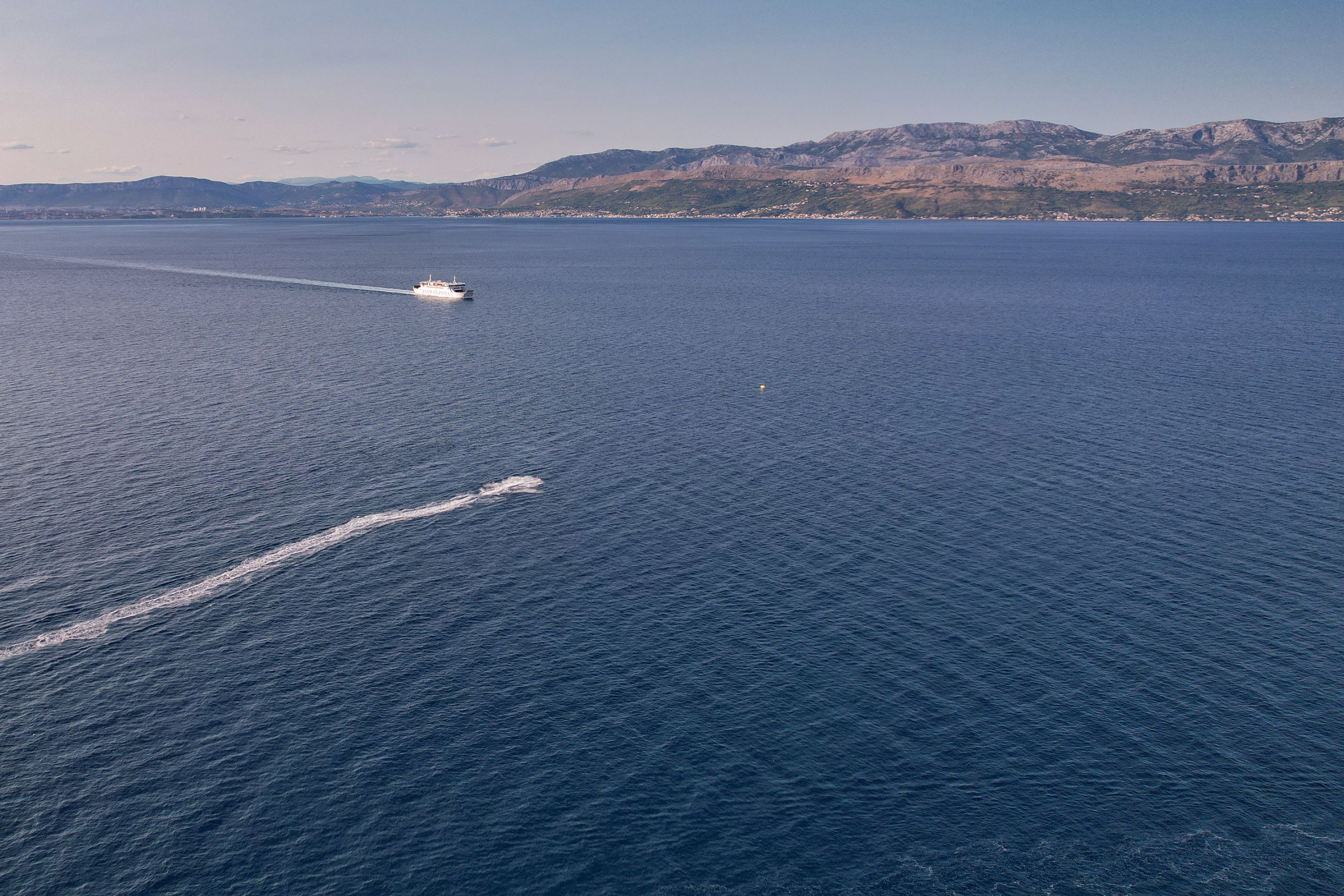 A boat is traveling across the water in the ocean · Free Stock Photo
