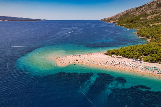Stunning aerial view of Zlatni Rat Beach in Croatia, a pristine summer destination with turquoise waters.