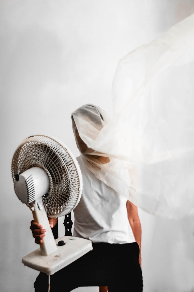 Man Holding Desk Fan