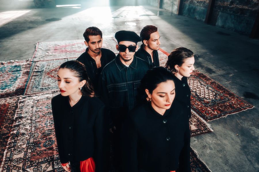 Ensemble of six people in dramatic low light — photo by Wolrider YURTSEVEN on Pexels