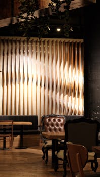 Stylish cafe interior featuring elegant furniture and contemporary decor with soft lighting.