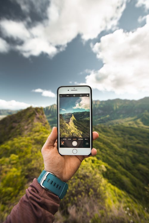 Person Showing Photo of Mountains