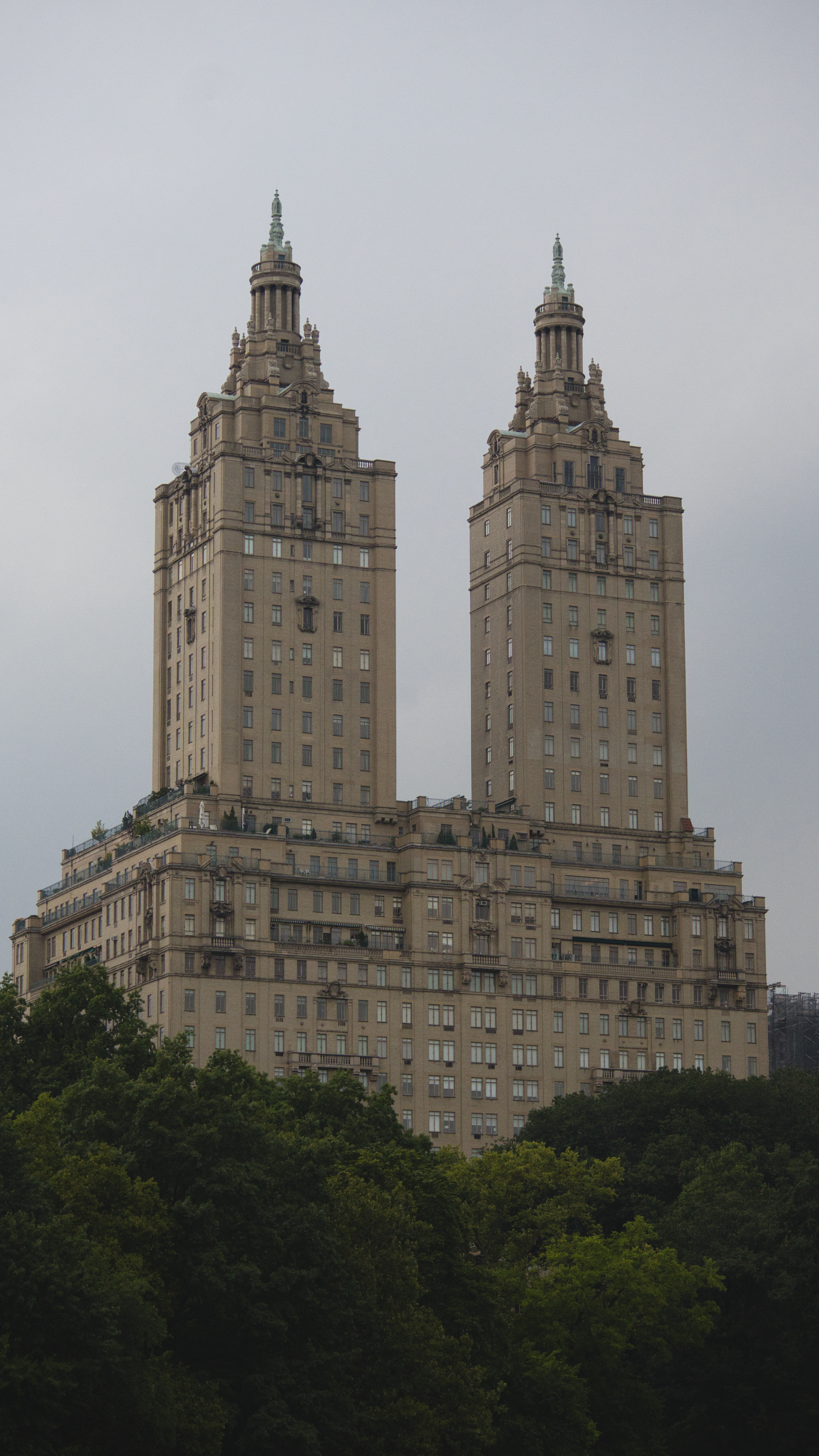 Two tall buildings with two towers in the background · Free Stock Photo