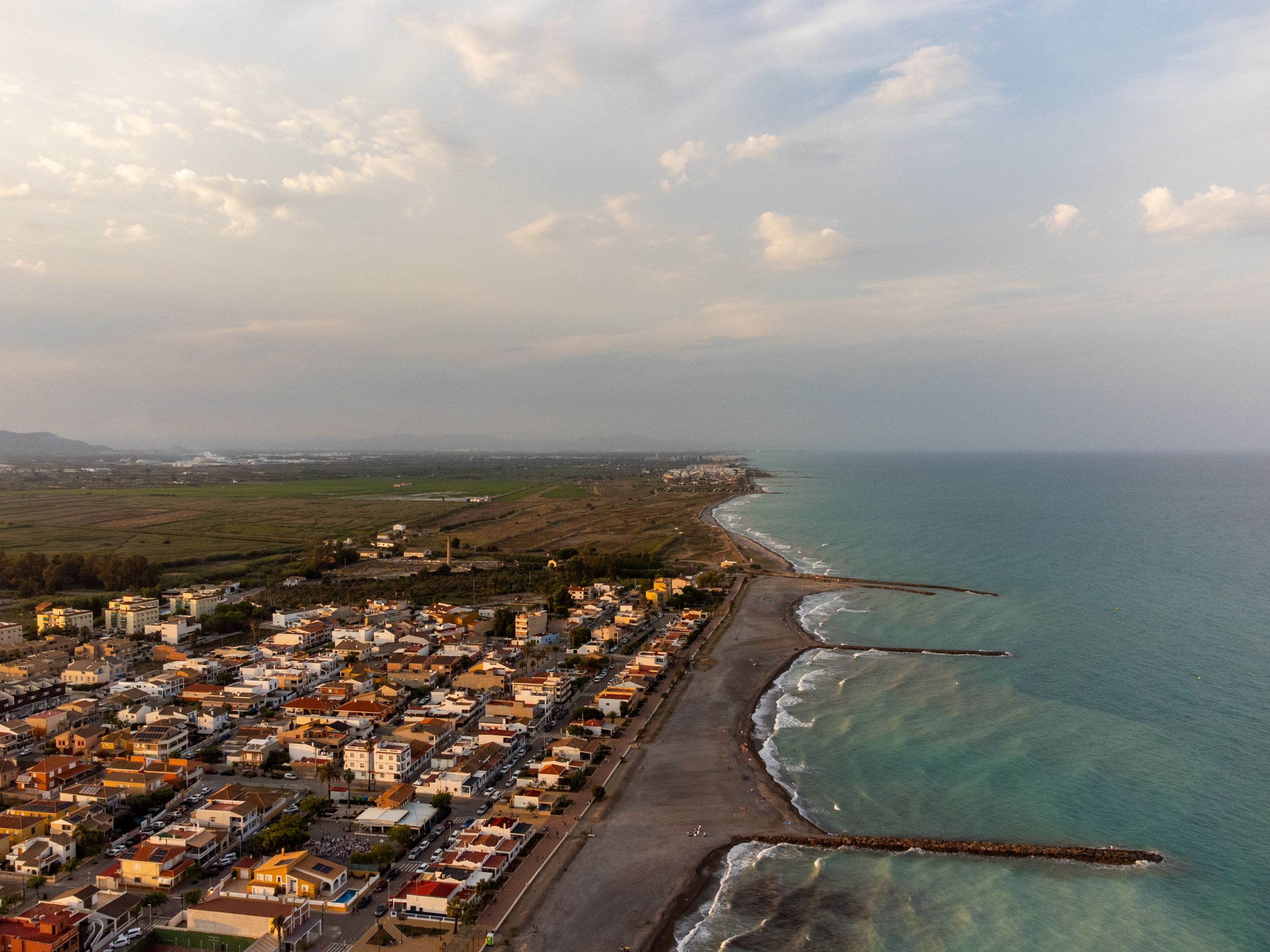 Unbeatable Barcelona Official Helicopter Tour with In-flight Audio Review 2026 - Stunning aerial view of Casablanca, Spain's coastline at sunset with tranquil seas and a beautiful cityscape.
