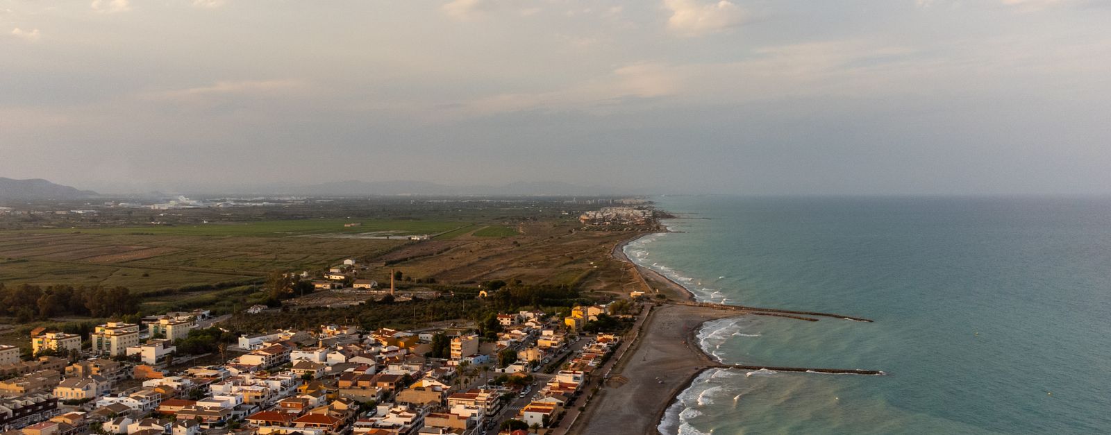 Stunning aerial view of Casablanca, Spain's coastline at sunset with tranquil seas and a beautiful cityscape.