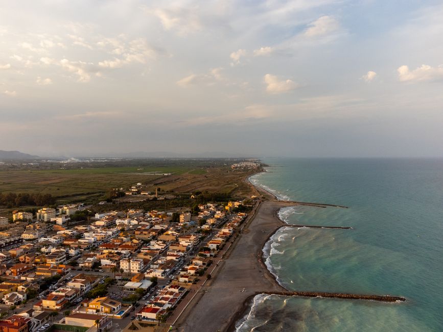 Unbeatable Barcelona Official Helicopter Tour with In-flight Audio Review 2026 - Stunning aerial view of Casablanca, Spain's coastline at sunset with tranquil seas and a beautiful cityscape.