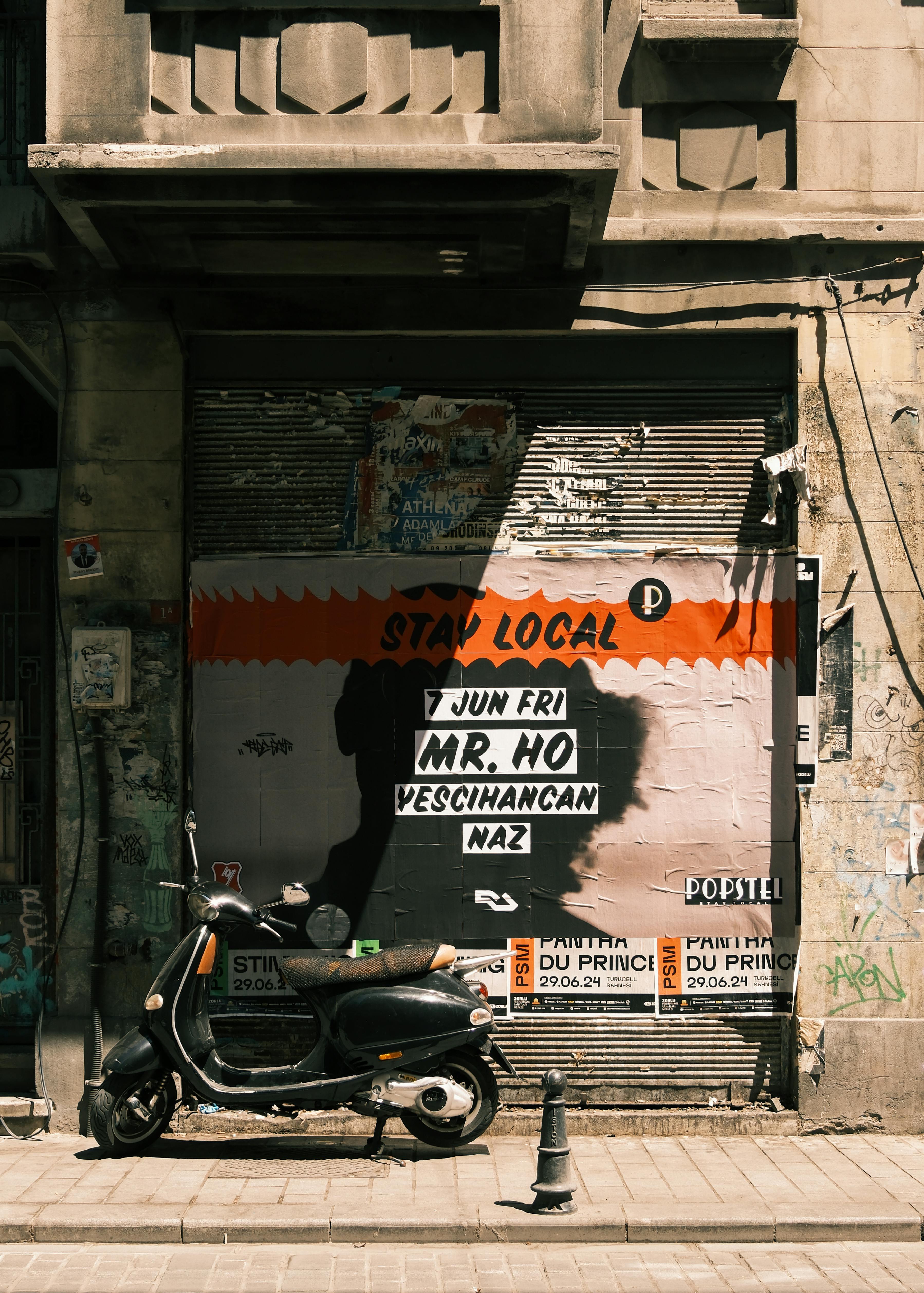 Capture of vibrant street art in Cihangir, Istanbul, with a parked scooter against an artistic backdrop.