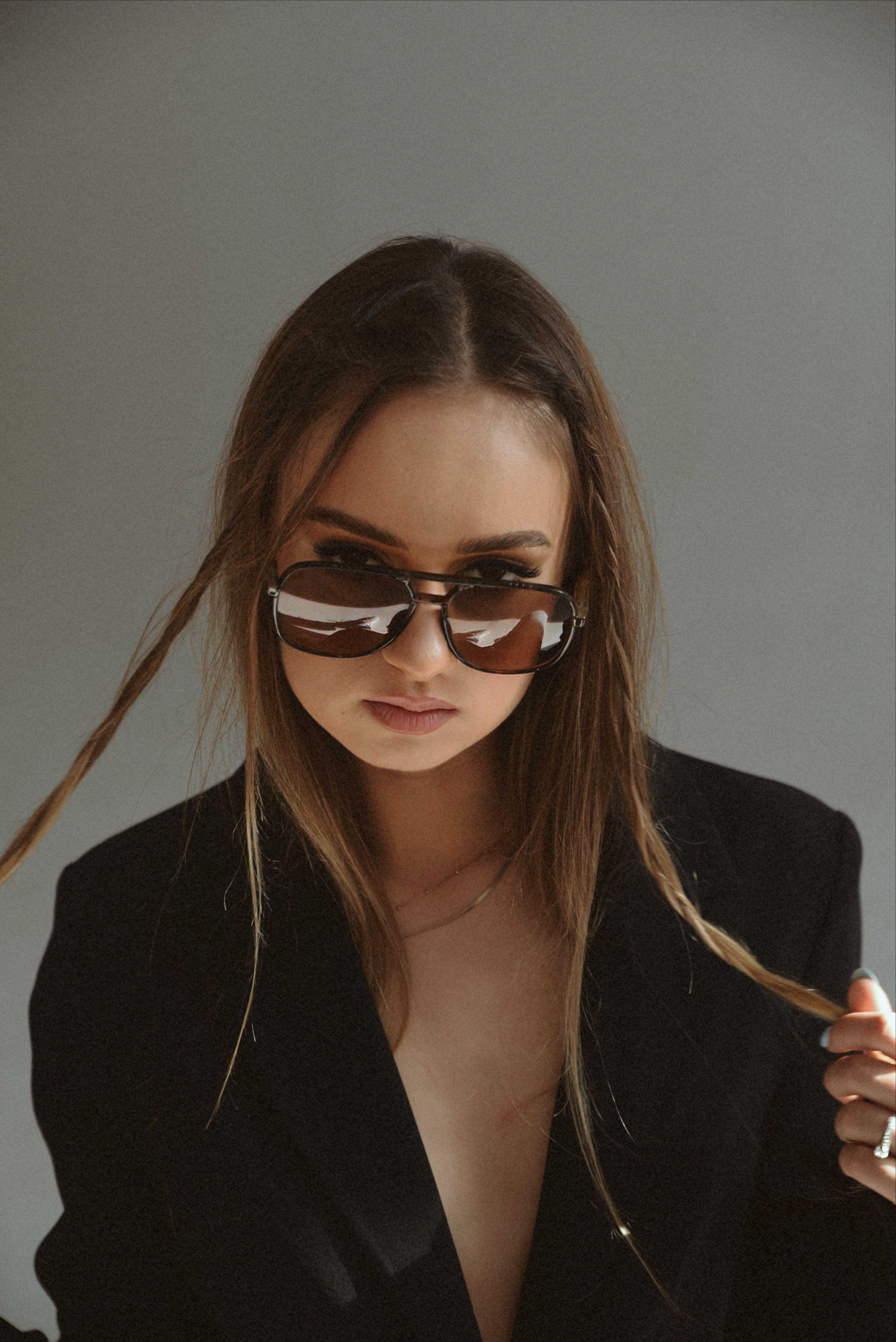 A woman in a black suit and sunglasses · Free Stock Photo