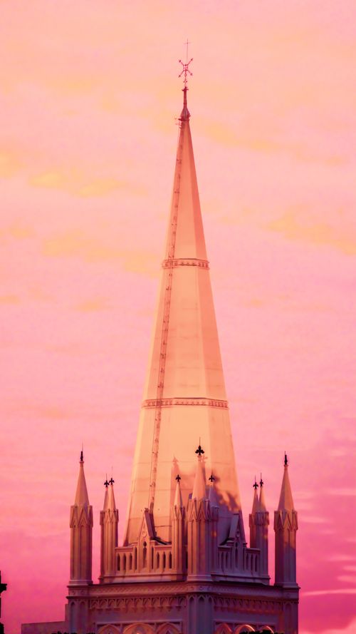 Free Stunning cathedral spire silhouetted against a vivid sunset sky, showcasing religious architecture. Stock Photo