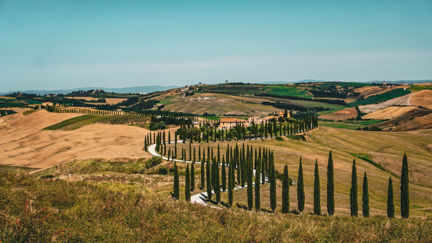 Rolling hills and cypress trees in the Tuscan countryside