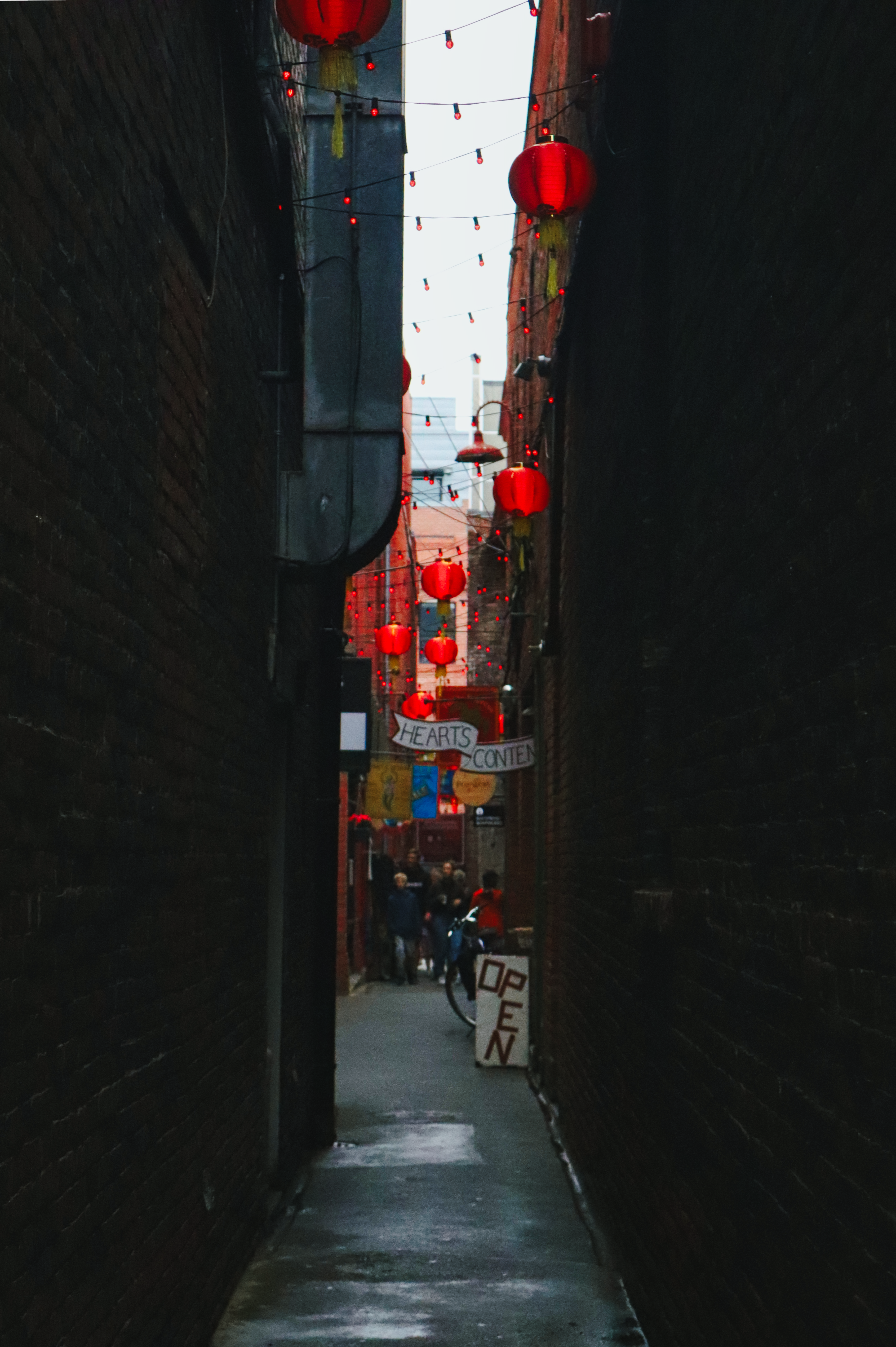 A narrow alley with red lanterns hanging from the ceiling · Free Stock ...